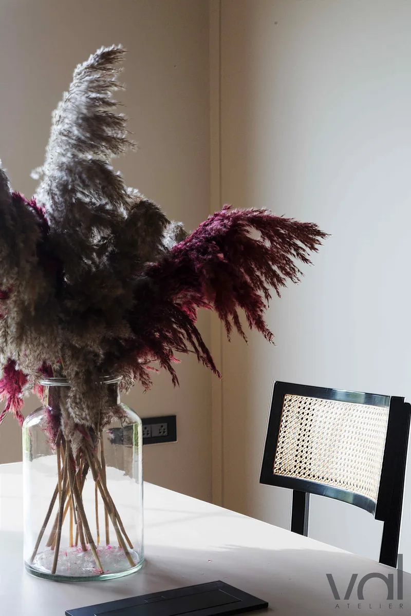 Dried stems and a cane chair in the Val Atelier studio
